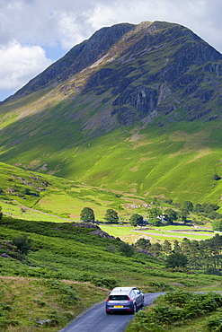 Motorist touring by Wasdale Fell and Wastwater in the Lake District National Park, Cumbria, UK