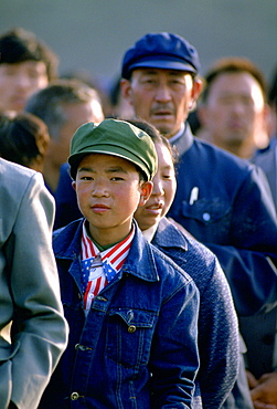 Chinese boy wearing a patriotic American stars and stripes shirt and denim jacket queues to enter the Great Hall of the People  in Tiananmen Square, Beijing, China