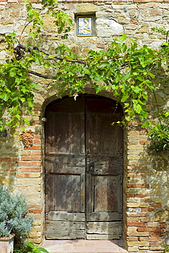 Ancient doorway and religious painting at Il Rigo agritourismo hotel and farmhouse, San Quirico d'Orcia, in Val D'Orcia area Tuscany, Italy