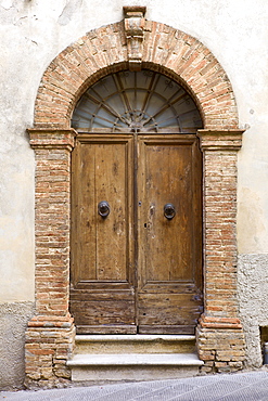 Traditional doorway in old hill town of Montalcino, Val D'Orcia,Tuscany, Italy