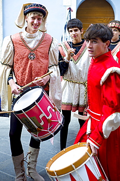 Contrada members in livery costumes for traditional parade in Asciano, inTuscany, Italy