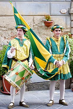 Contrada members in livery costumes for traditional parade in Asciano, inTuscany, Italy