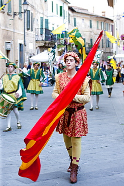 Contrada members in livery costumes for traditional parade in Asciano, inTuscany, Italy