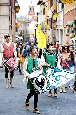 Contrada members in livery costumes for traditional parade in Asciano, inTuscany, Italy