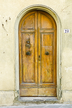 Traditional Tuscan doorway in Piazza Francesco Ferrucci in Radda-in-Chianti, Tuscany, Italy