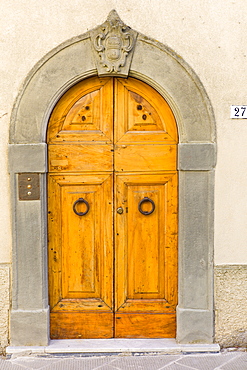 Traditional Tuscan doorway in Piazza Francesco Ferrucci in Radda-in-Chianti, Tuscany, Italy