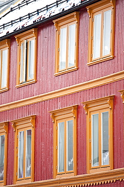 Traditional architecture and snow guards on roof in Storgata in city of Tromso, in the Arctic Circle in Northern Norway