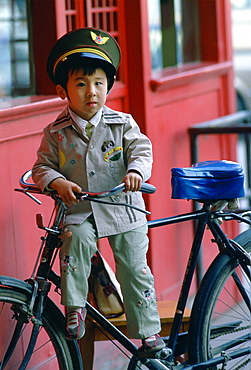 Boy on a bike wearing uniform in Beijing, China