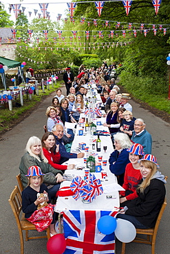 Street party with Union Jack flags and bunting to celebrate Queen's Diamond Jubilee at Swinbrook in The Cotswolds, UK