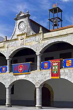 Spanish banners at medieval building in Plaza de la Constitucion 19 March 1812 in Laredo, Cantabria, Spain