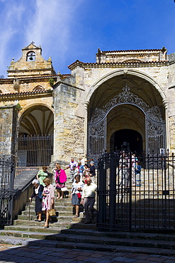 Roman Catholic worshippers leaving Mass in the church Iglesia Santa Maria de la Asuncion, Laredo, Cantabria, Spain