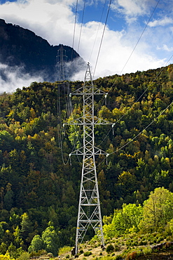 Electricity pylons cross the landscape in Valle de Tena the Pyrenees mountain range in Aragon, Northern Spain