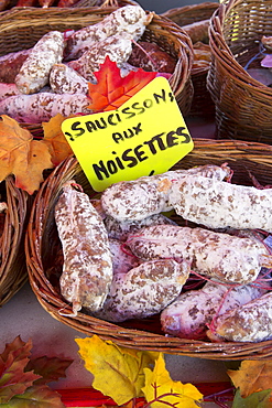 Traditional French sausages made with hazelnuts, saucissons aux noisettes, on sale at food market in Normandy, France