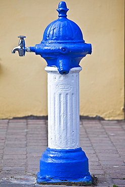 Blue and white drinking fountain water tap in Ardmore Village, County Waterford, Southern Ireland