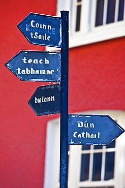 Gaelic signpost to Kinsale and other destinations in Timoleague, County Cork, Ireland