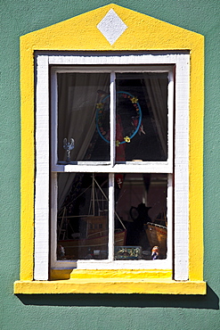 Aquamarine colour wall and yellow window border in Kinsale, County Cork, Ireland