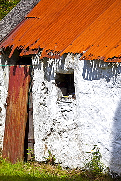 Whitewashed barn with rusty corrugated iron roof in County Cork, Ireland