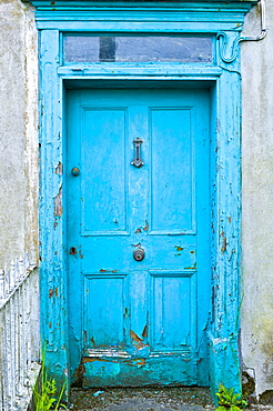 Brightly painted weathered doorway of quayside house in Courtmacsherry, County Cork, Ireland