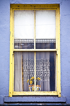 Lace curtains and a lace-trimmed roller blind in typical window in Ennistymon (Ennistimon), County Clare, West of Ireland