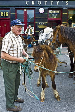 Horse fair in market square in Kilrush, Co. Clare, Ireland. Traditional for locals and travellers to trade horses and ponies