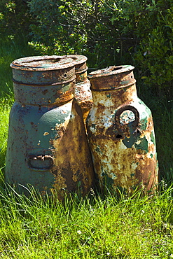 Old rusty galvanised iron milk creamery churns in County Clare, West of Ireland