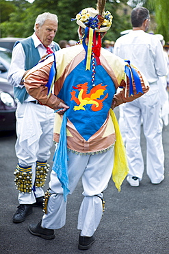 Morris dancers, Icknield Way Morris Men, chat after dancing display at The Kings Head Pub in Bledington, Oxfordshire, UK