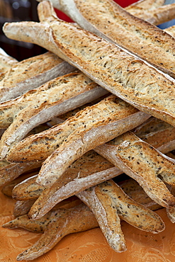 Freshly-baked multigrain 5 cereals French baguette bread on sale at food market at La Reole in Bordeaux region of France