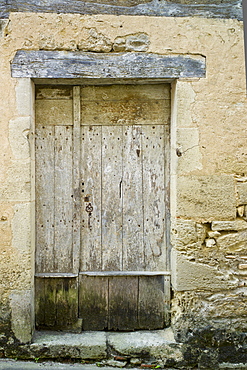 Traditional old wooden French doorway in quaint town of Castelmoron d'Albret in Bordeaux region, Gironde, France