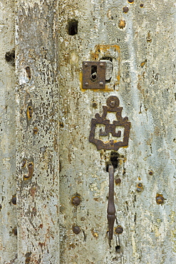 Traditional French lock in a doorway in quaint town of Castelmoron d'Albret in Bordeaux region, Gironde, France