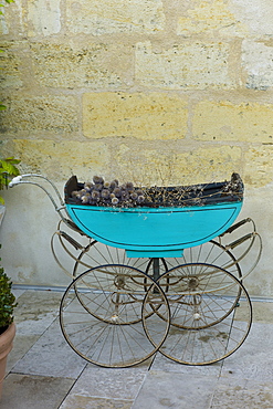 Antique traditional pram with dried grasses in St Emilion, Bordeaux, France