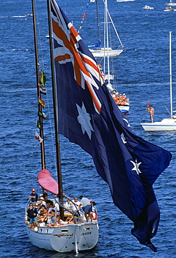 Australian flag being flown in boat by Sydney Harbour for Australia's Bicentenary, 1988