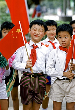 Schoolchildren with Chinese flags at  Xian, China in the 1980s