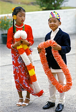 Nepalese children in traditional costumes with traditional welcome garlands