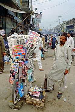 Man selling newspapers stacked on a bicycle in the streets of Islamabad in Pakistan