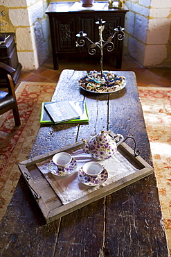 Tea tray with teapot and floral china cups in hotel, Hostellerie Les Griffons, Bourdeilles, North Dordogne, France