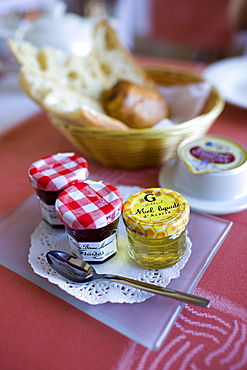 French jam honey butter bread and pain au chocolat breakfast at Hostellerie Les Griffons, Bourdeilles, Dordogne, France