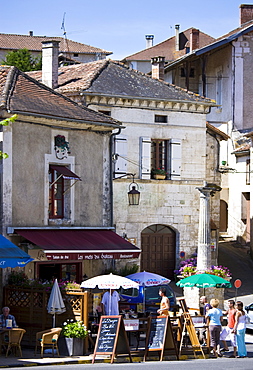 Tourists in quaint town of Bourdeilles popular tourist destination near Brantome in Northern Dordogne, France