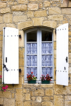 Traditional French window lace curtains shutters window boxes in picturesque Sarlat, Dordogne, France