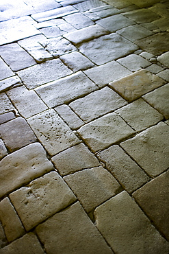 Old stone floor in the ancient church at St Amand de Coly in the Dordogne, France