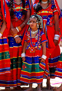 Young pretty girls in brightly coloured national costume and jewels at a festival in Calcutta, India