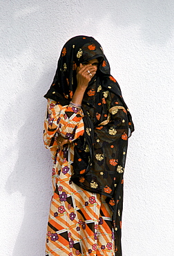 Shy young girl modestly dressed in Muscat in Oman, Middle East