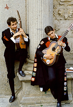 Musicians playing classical guitar at a cultural event in Portugal