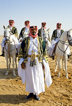 Bedouins with horses in the desert in Saudi Arabia