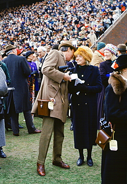 Spectactors in front of grandstand at Cheltenham Racecourse for the National Hunt Festival of Racing, UK