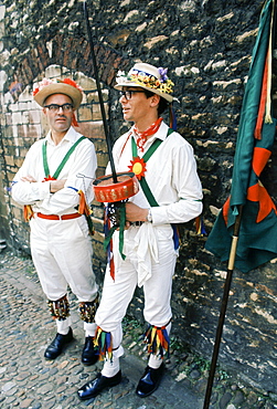 Traditional English Morris Men in costume with bells and floral hats at a Morris dancing festival in Cambridge, UK