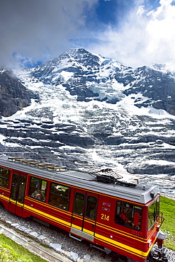 Jungfraubahn funicular train with Eiger Glacier (Eigergletscher) behind in Swiss Alps, Bernese Oberland, Switzerland, Europe