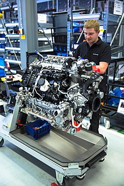 Engineer at work hand-building one complete M157 5.5L V8 biturbo engine, Mercedes-AMG engine production factory in Affalterbach, Bavaria, Germany, Europe