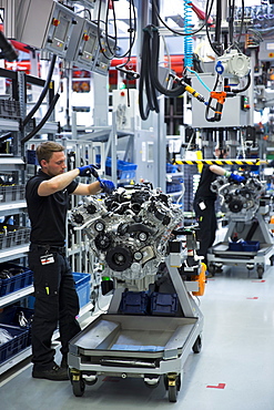 Engineer at work hand-building one complete M157 5.5L V8 biturbo engine, Mercedes-AMG engine production factory in Affalterbach, Bavaria, Germany, Europe