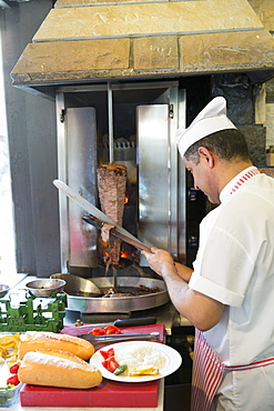 Chef at Ciya Sofrasi Turkish restaurant slicing lamb doner kebab in Kadikoy district, Asian side Istanbul, East Turkey, Asia Minor, Eurasia