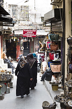 Muslim women wearing traditional robes and veils shopping in The Grand Bazaar (Great Bazaar) (Kapali Carsi), Beyazi, Istanbul, Turkey, Europe